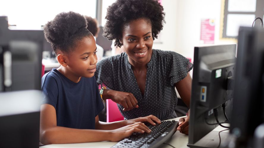 Student and teacher at computer